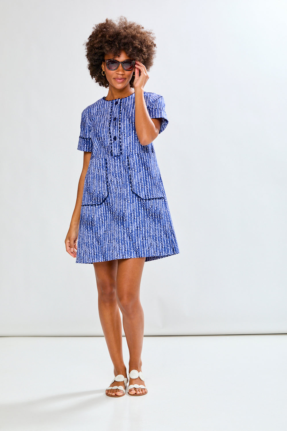 Woman wearing a blue dress with a white background