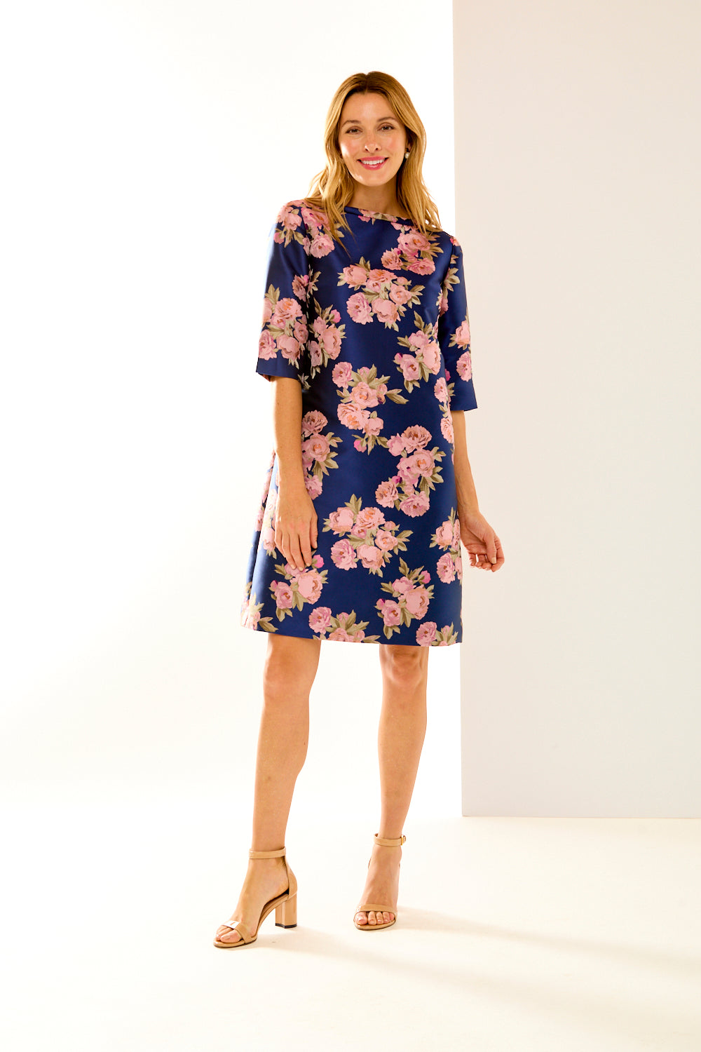 Woman in navy roses dress