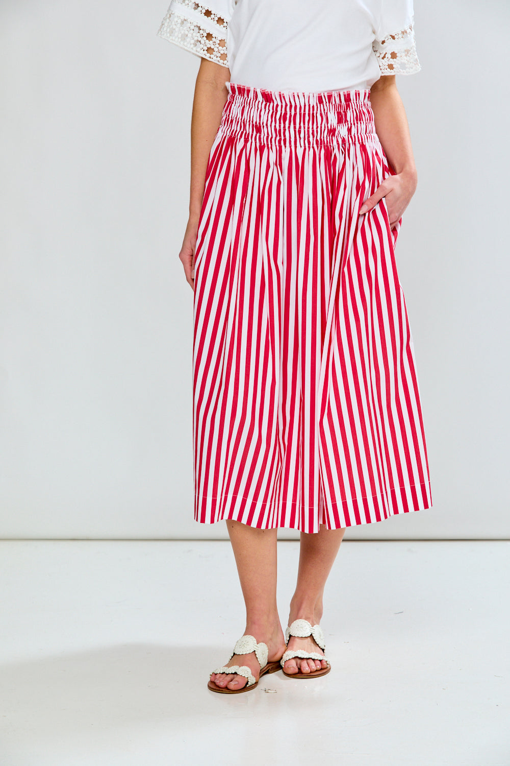 Woman in red & white stripe skirt