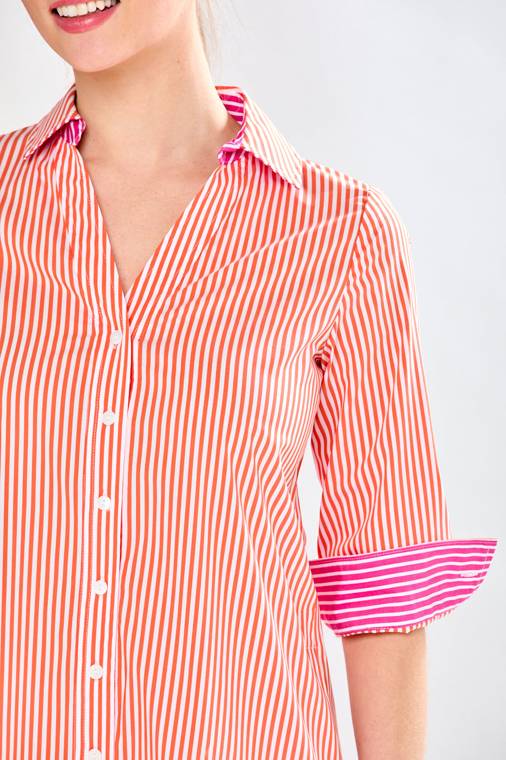 Woman in fuchsia and orange stripe dress