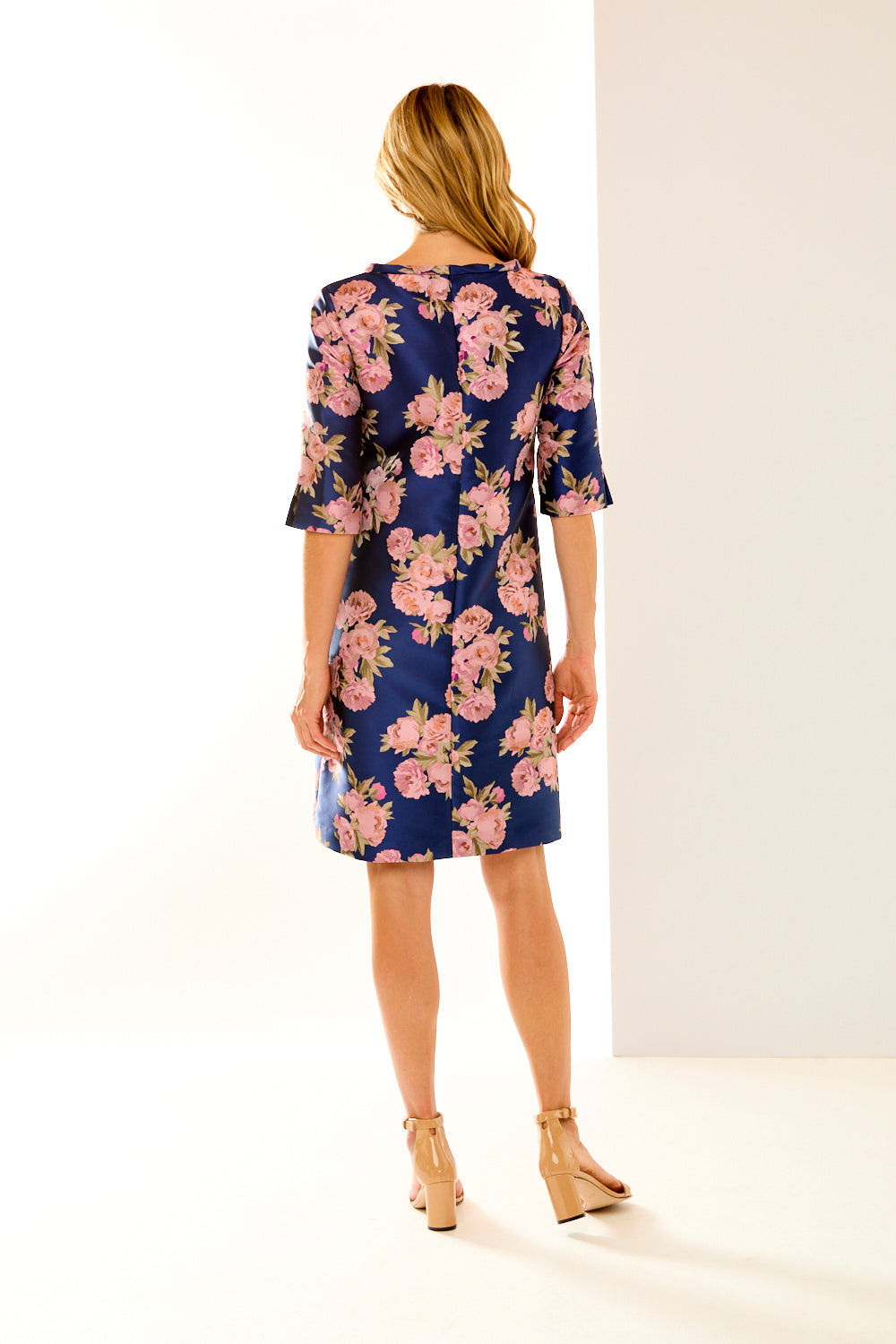 Woman in navy roses dress