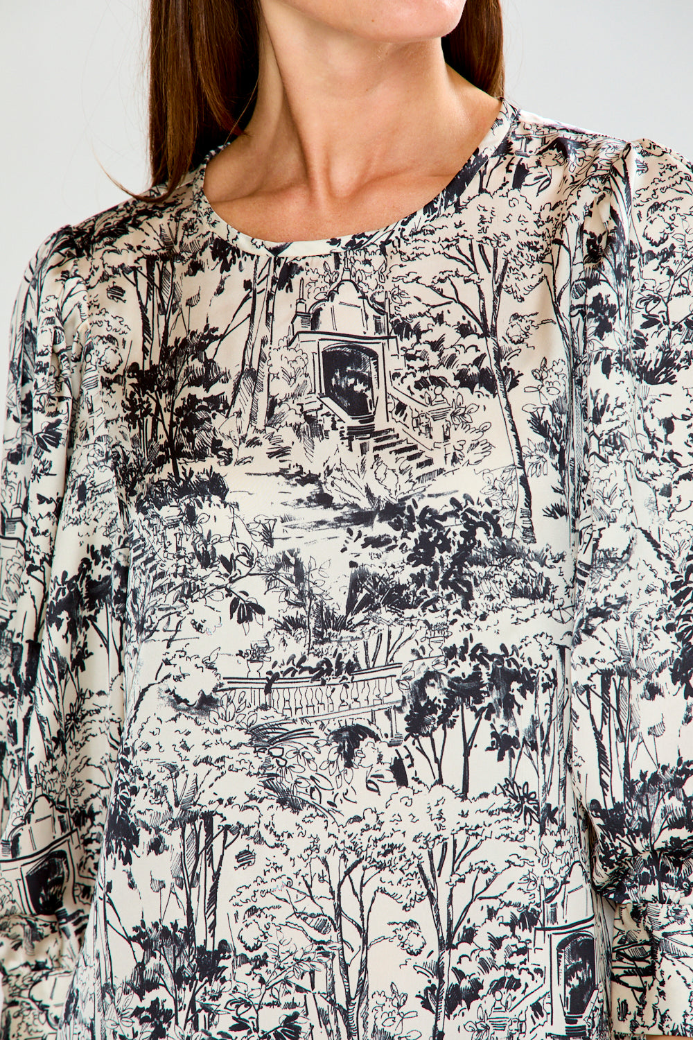 Woman wearing a patterned dress on a white background