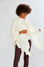 Woman wearing a white scarf against a plain background