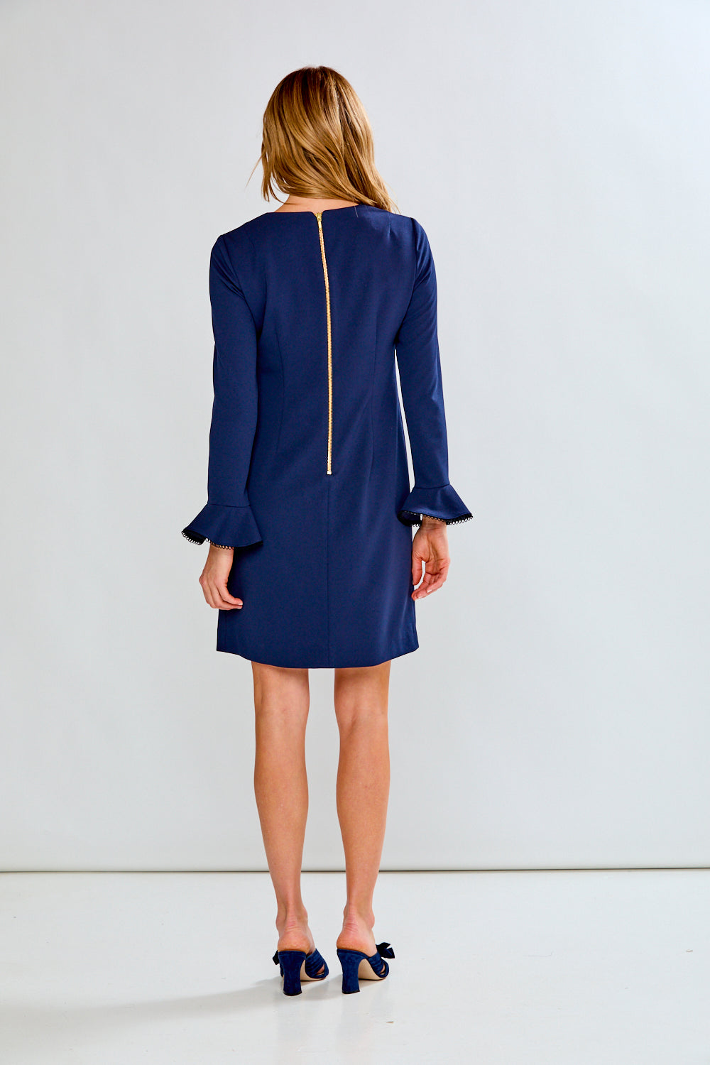 Woman in navy crepe dress