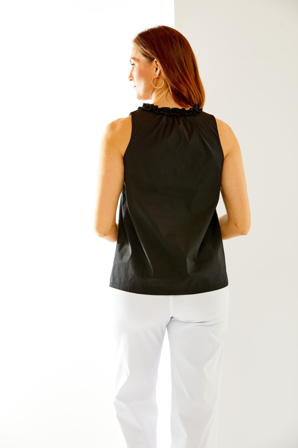 Woman in black sleeveless top