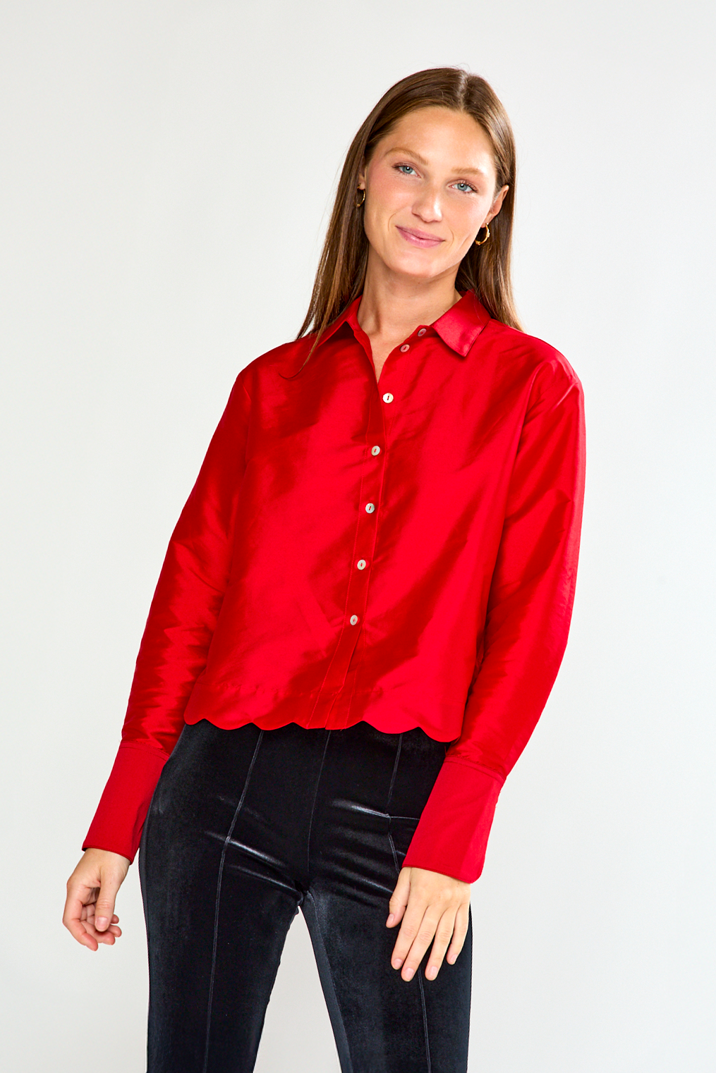 Woman wearing a red shirt against a white background
