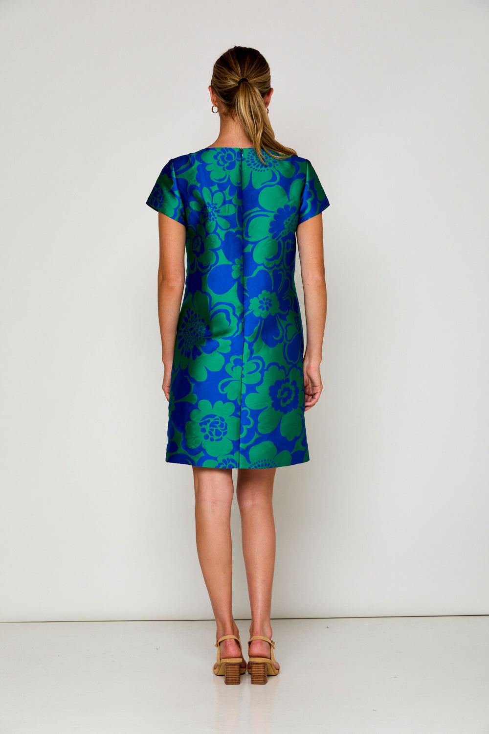 Woman in blue and green floral dress