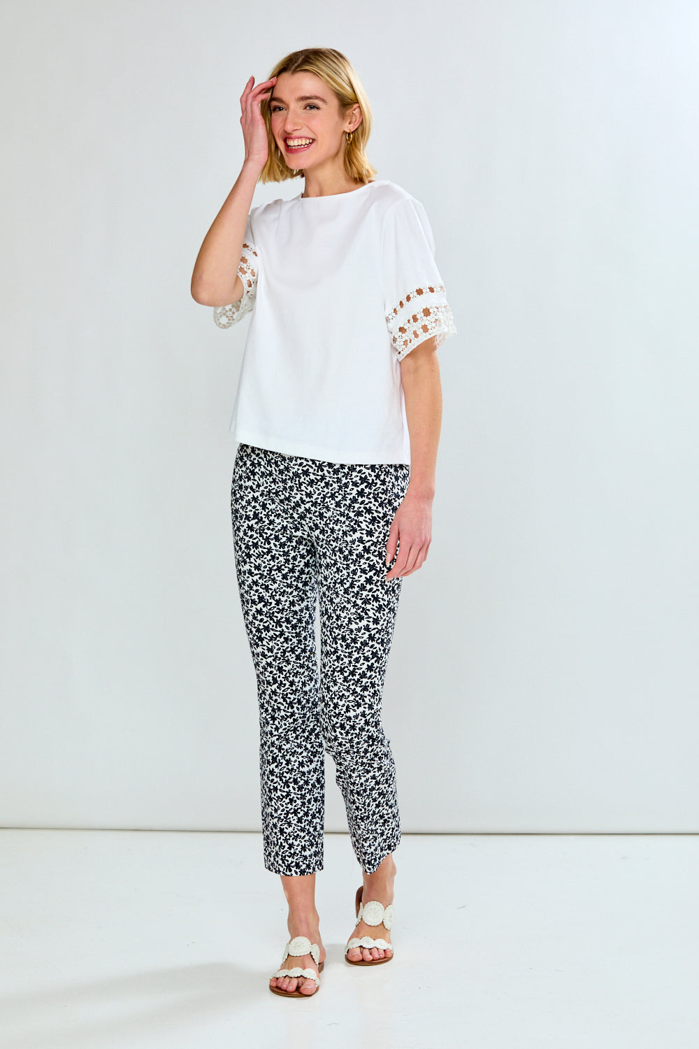 Woman in white top and printed pants