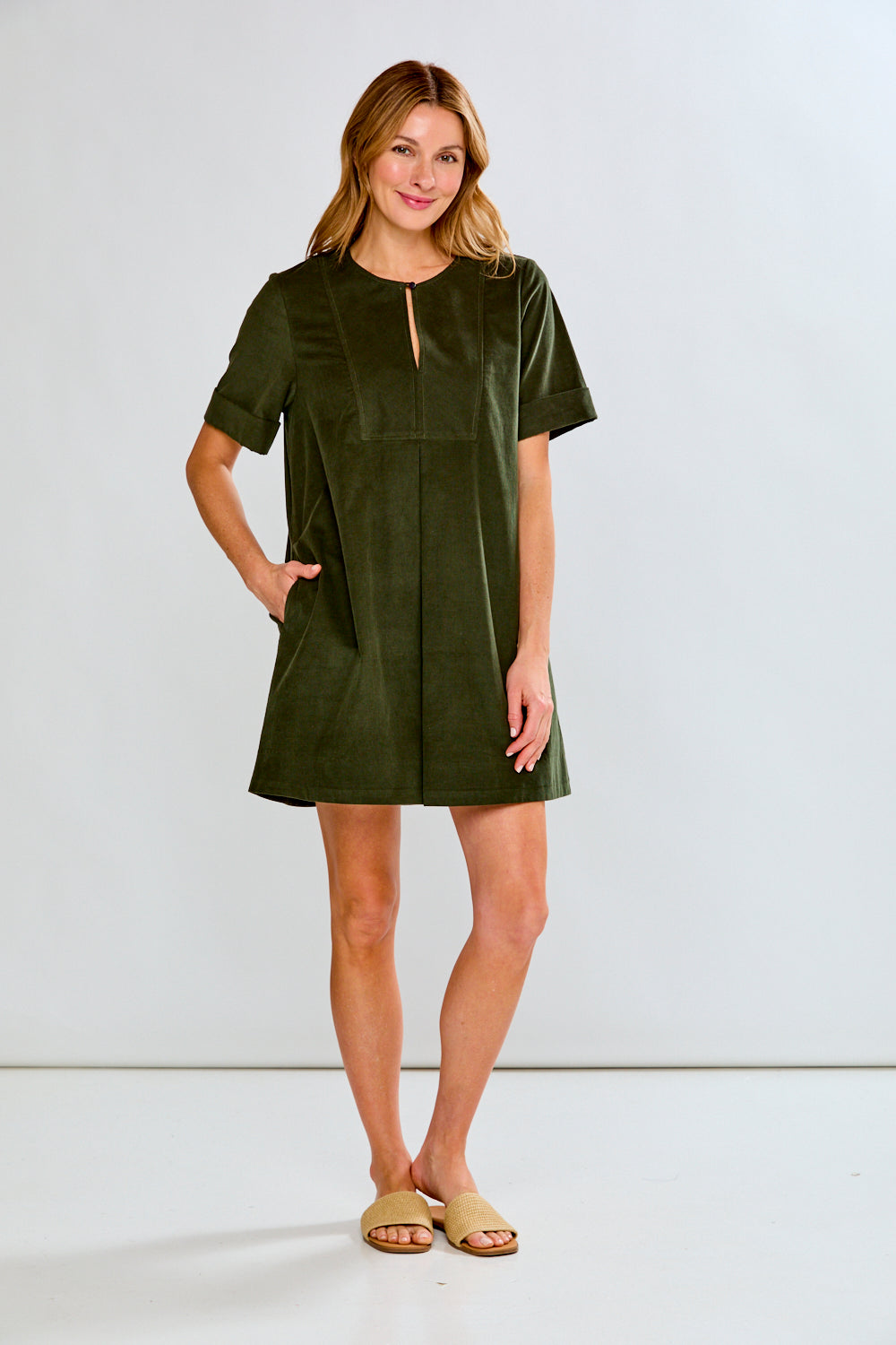 Woman wearing a green dress against a white background