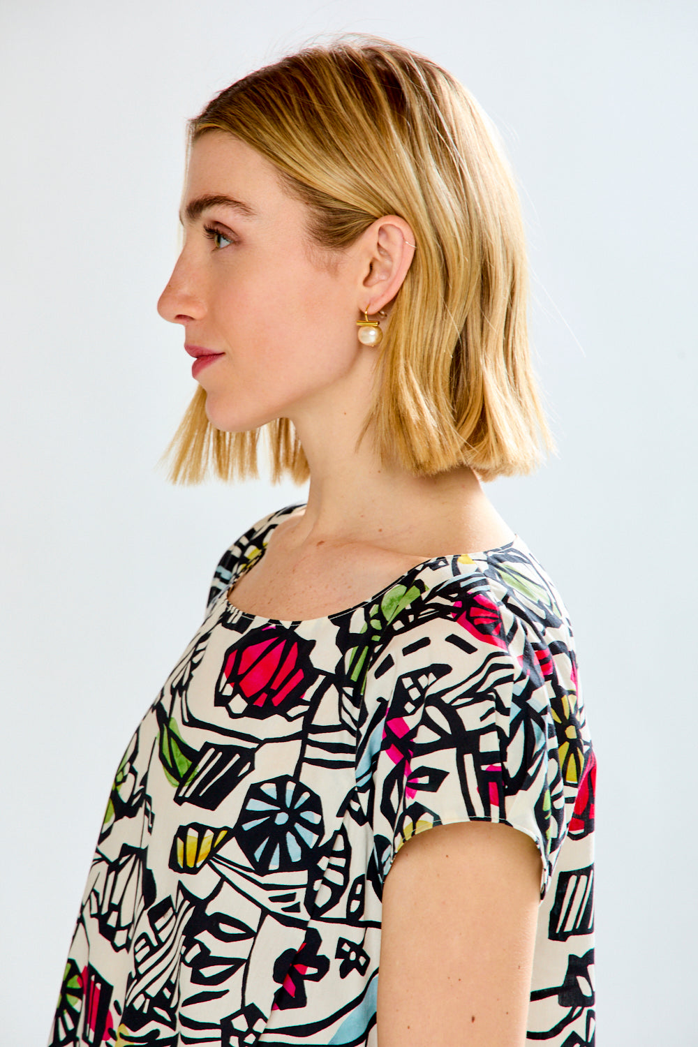 Woman wearing a printed dress on a white background