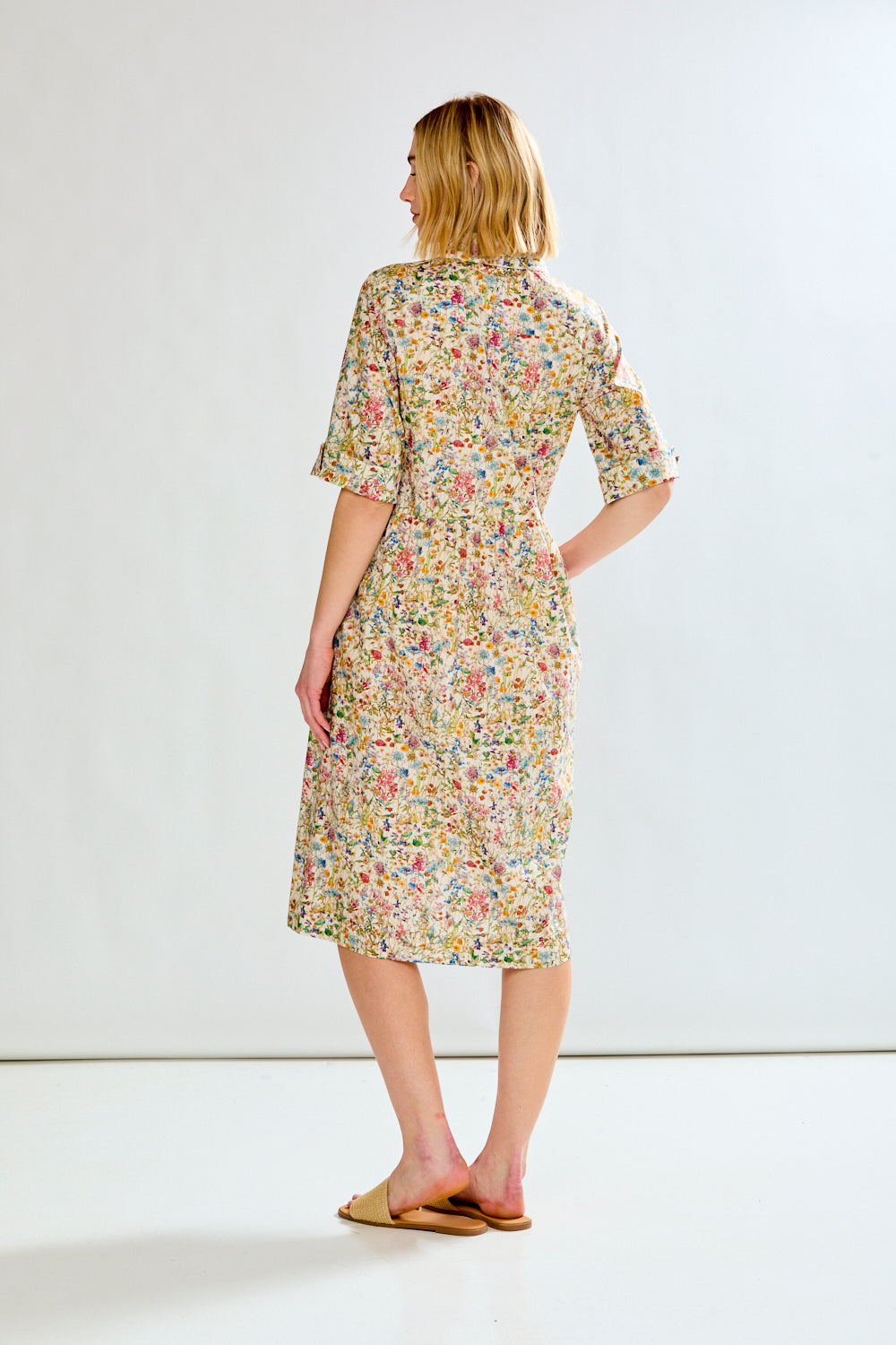 Woman wearing a floral dress on a white background