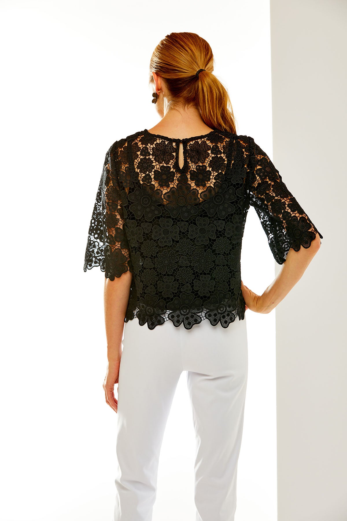 Woman in black lace top