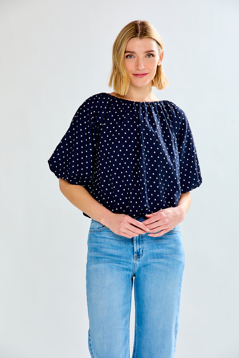 woman with polkadot shirt and jeans