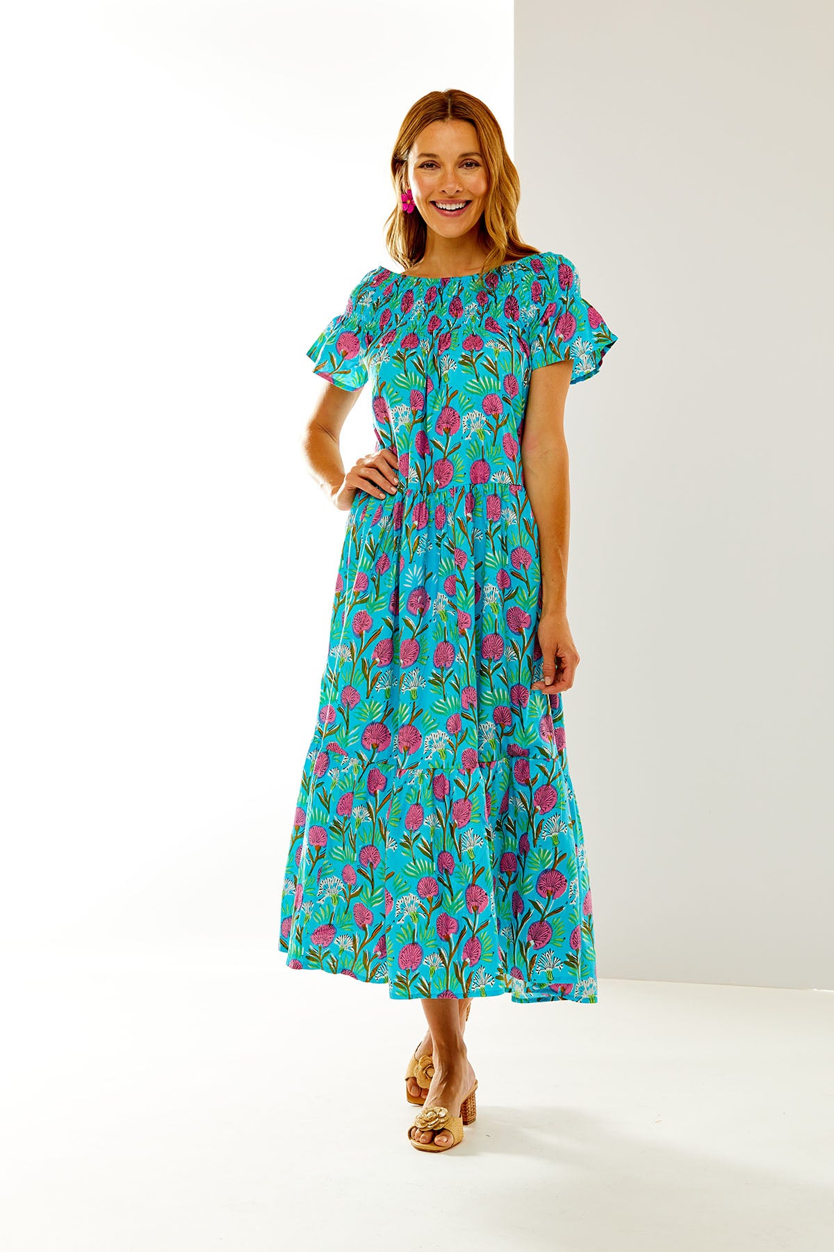 Woman in turquoise floral dress