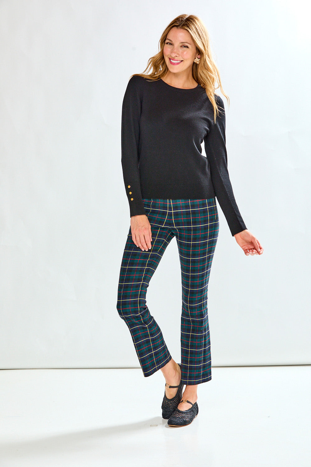 Woman wearing plaid pants on a white background