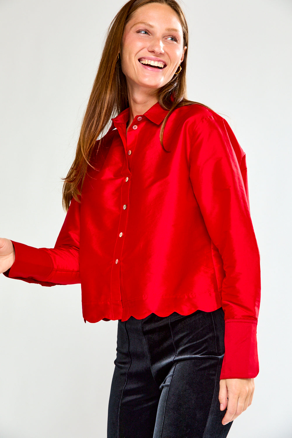 Woman wearing a red blouse against a white background