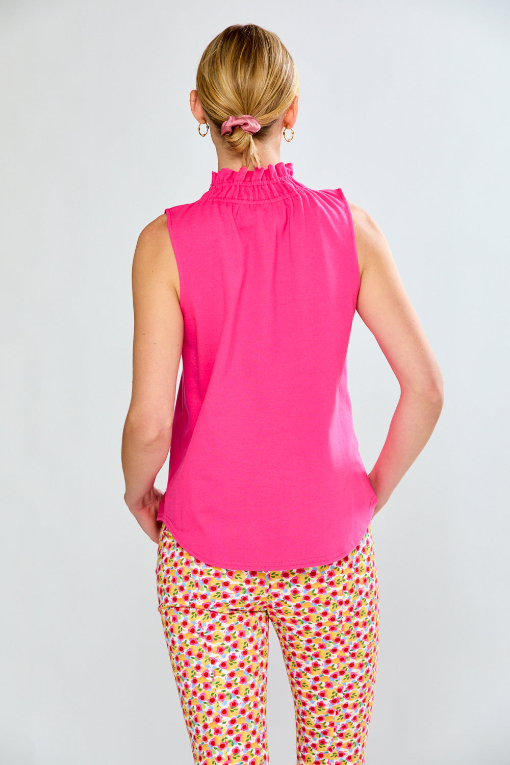 Woman in pink top and floral pants