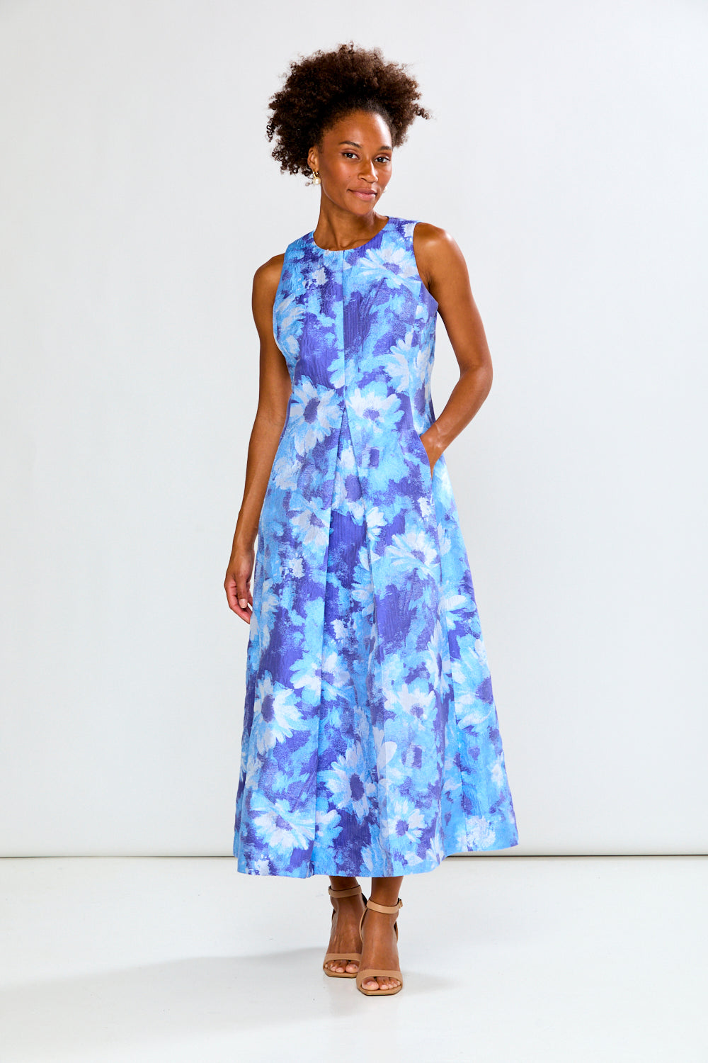 Woman wearing a blue floral dress on a white background