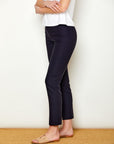 Woman in fitted navy colored pants