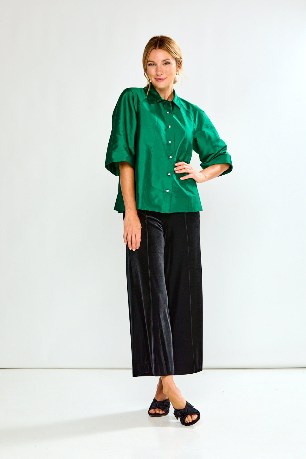 Woman wearing a green shirt with a collar on a white background