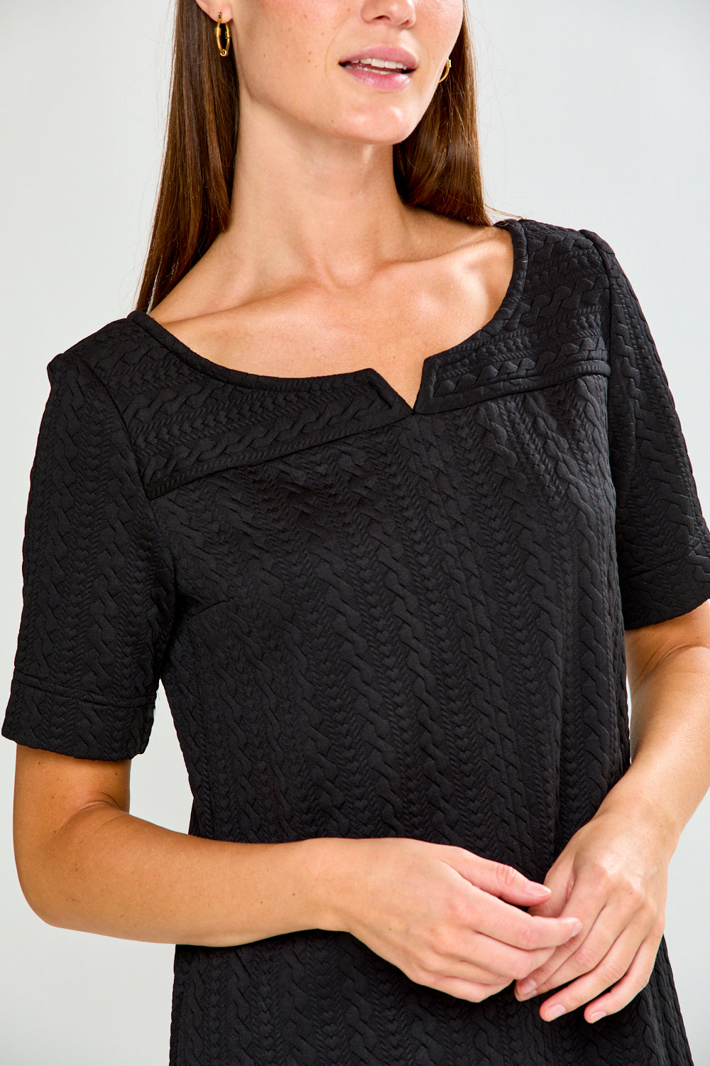 Woman wearing a black dress with a white background
