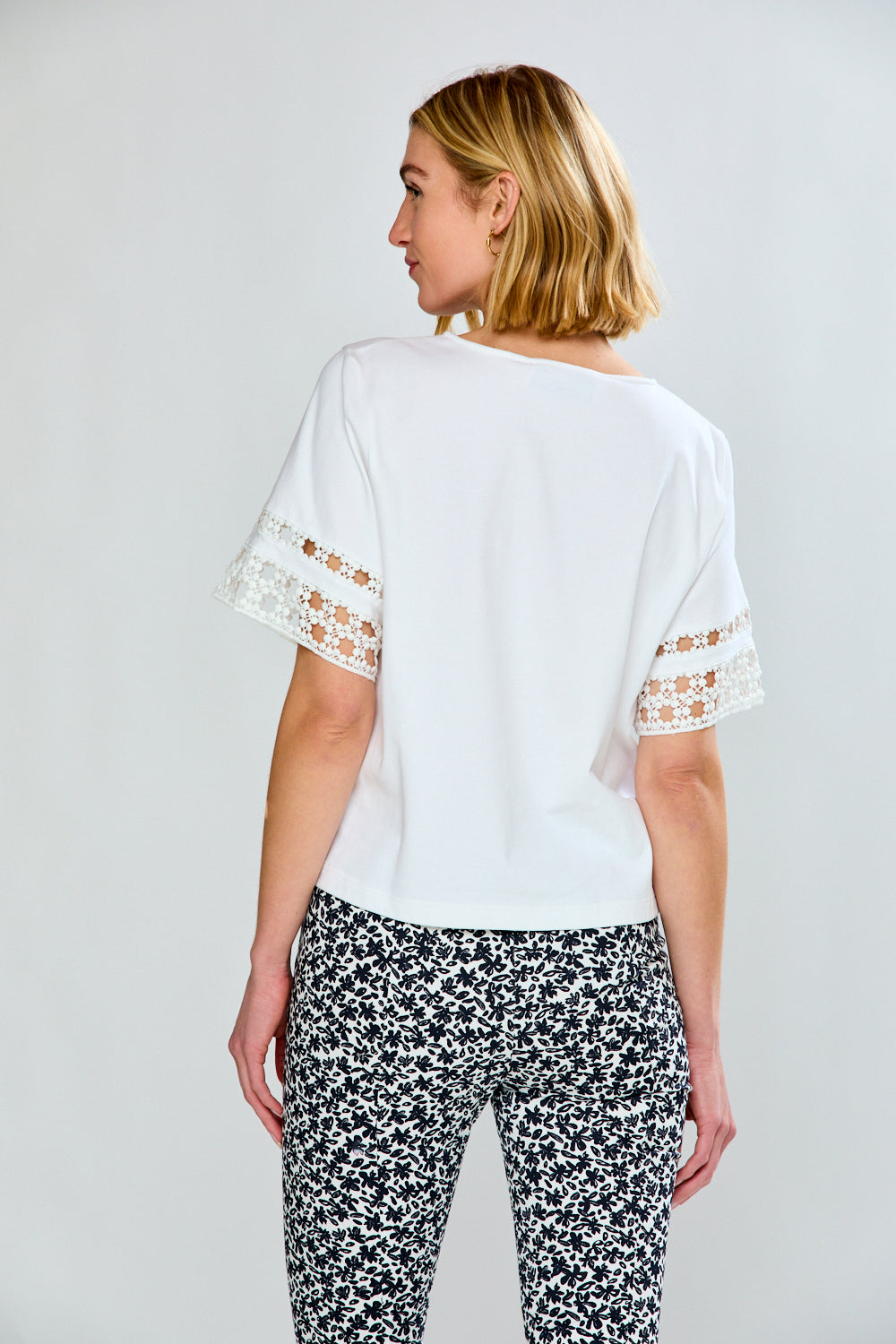 Woman in white top and printed pants