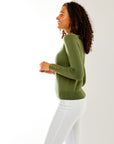 Woman in olive sweater