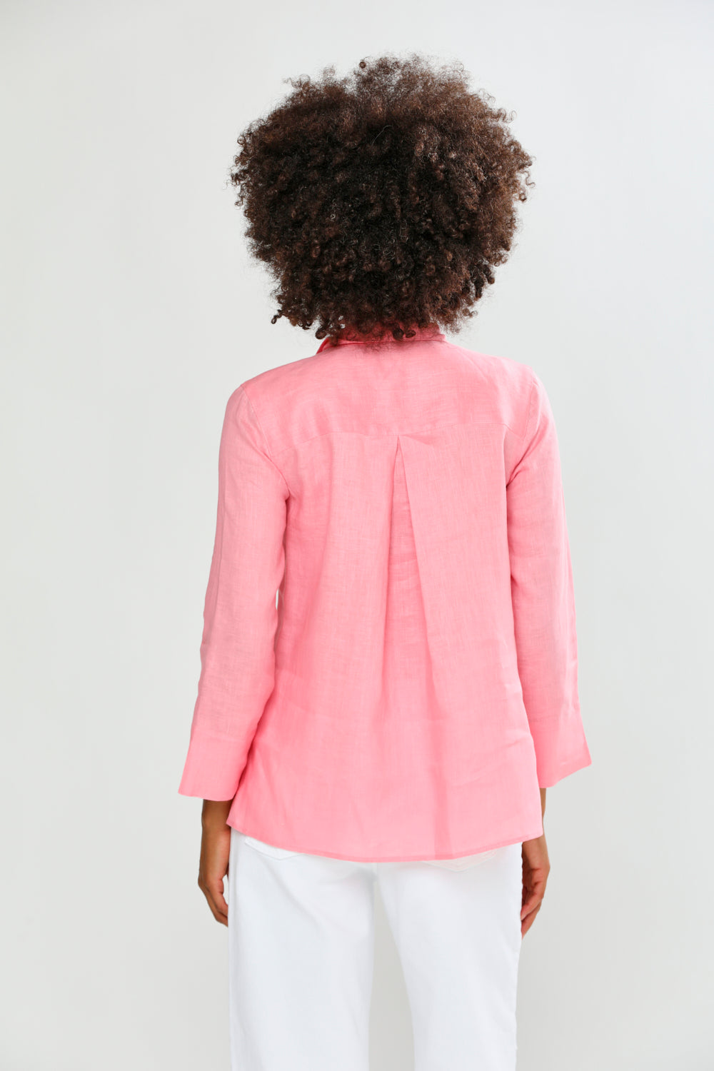 Person wearing a pink shirt on a white background