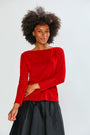 Woman wearing a red blouse and black skirt on a white background