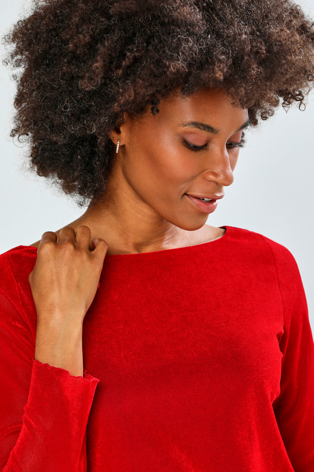 Woman wearing a red top against a white background