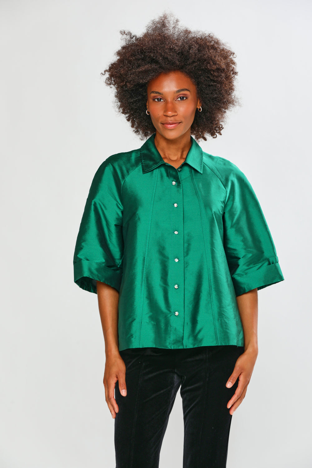 Woman wearing a green blouse against a white background
