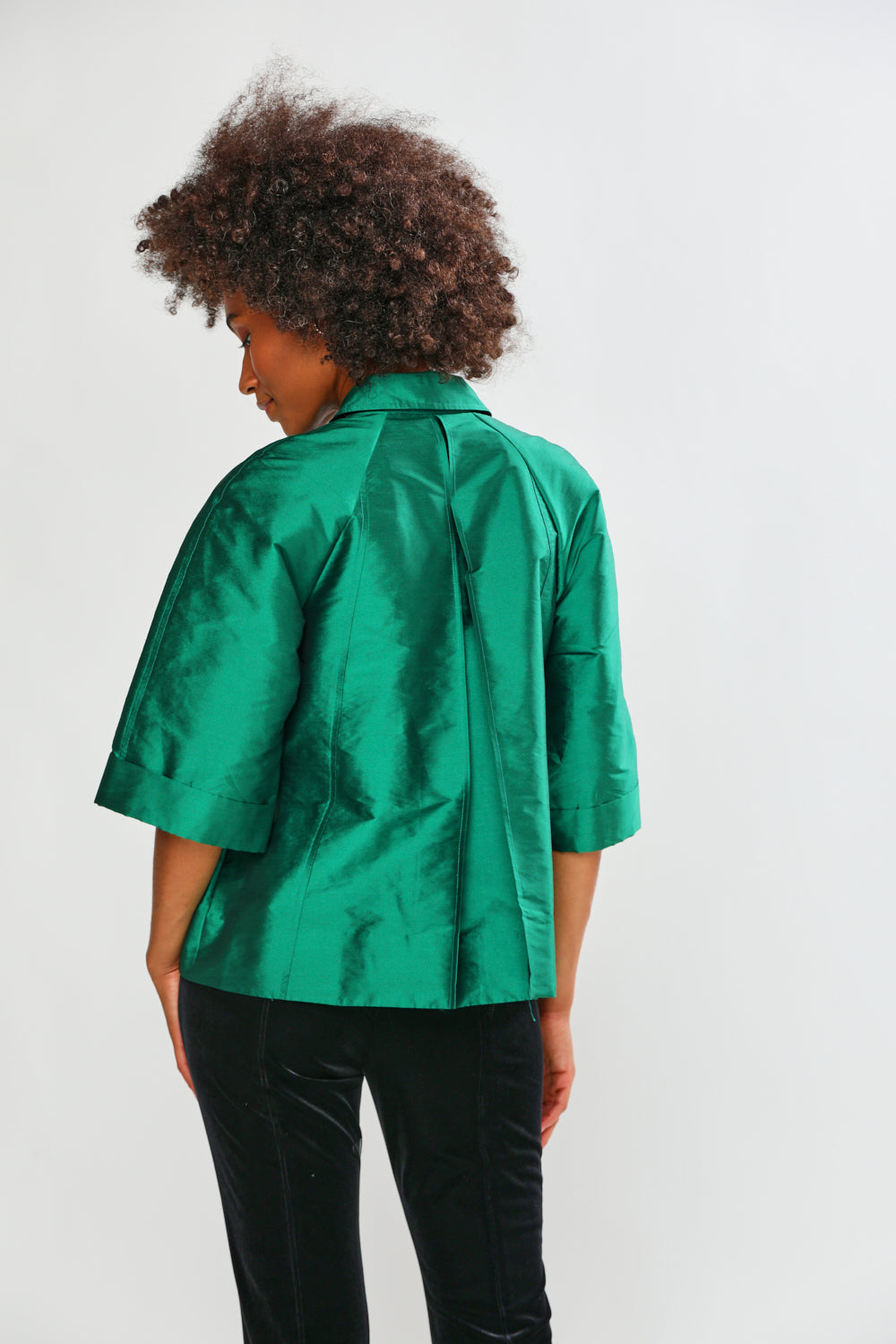 Person wearing a green blouse on a white background