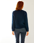Woman in navy sweater