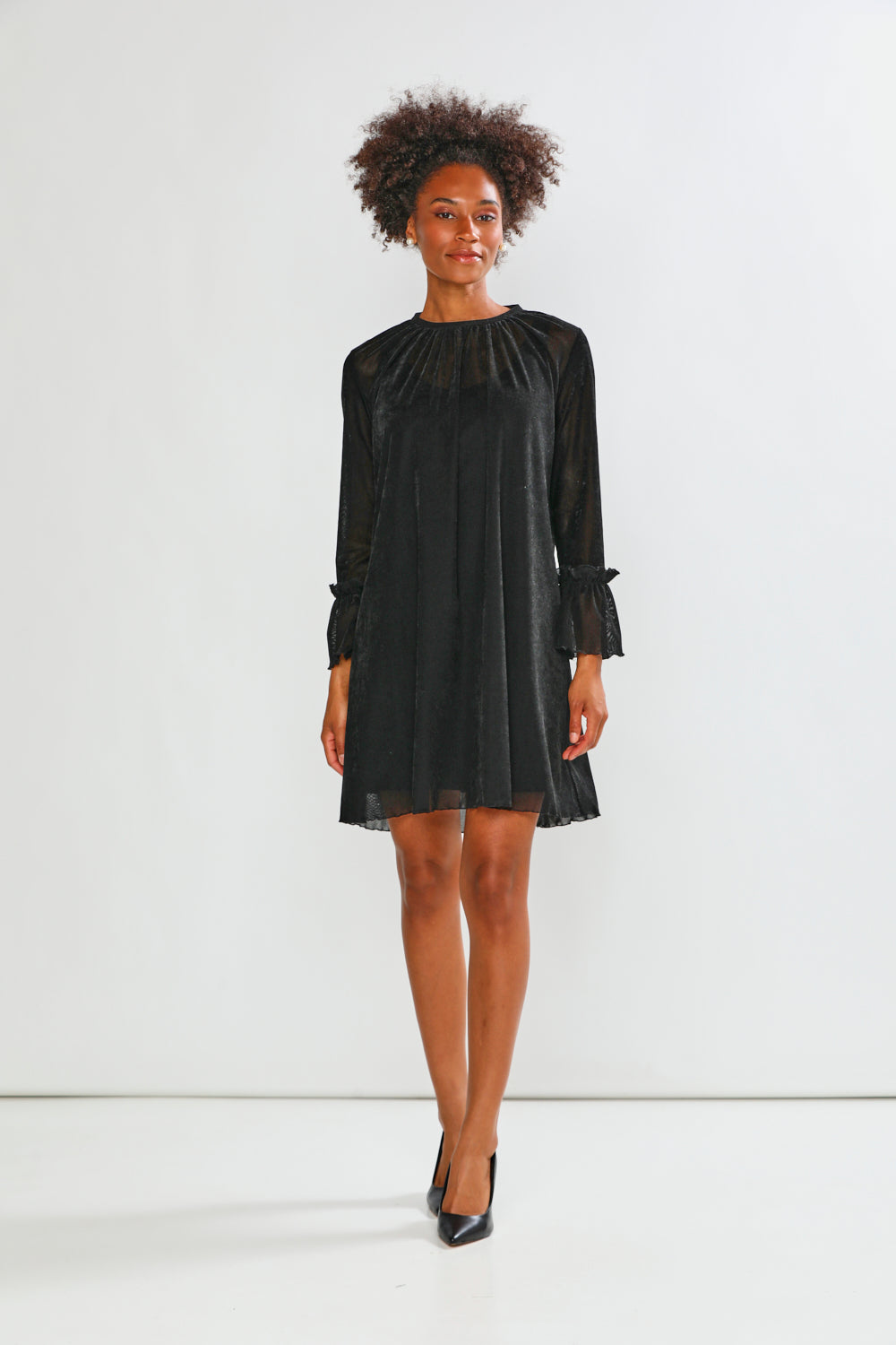 Woman wearing a black dress against a white background