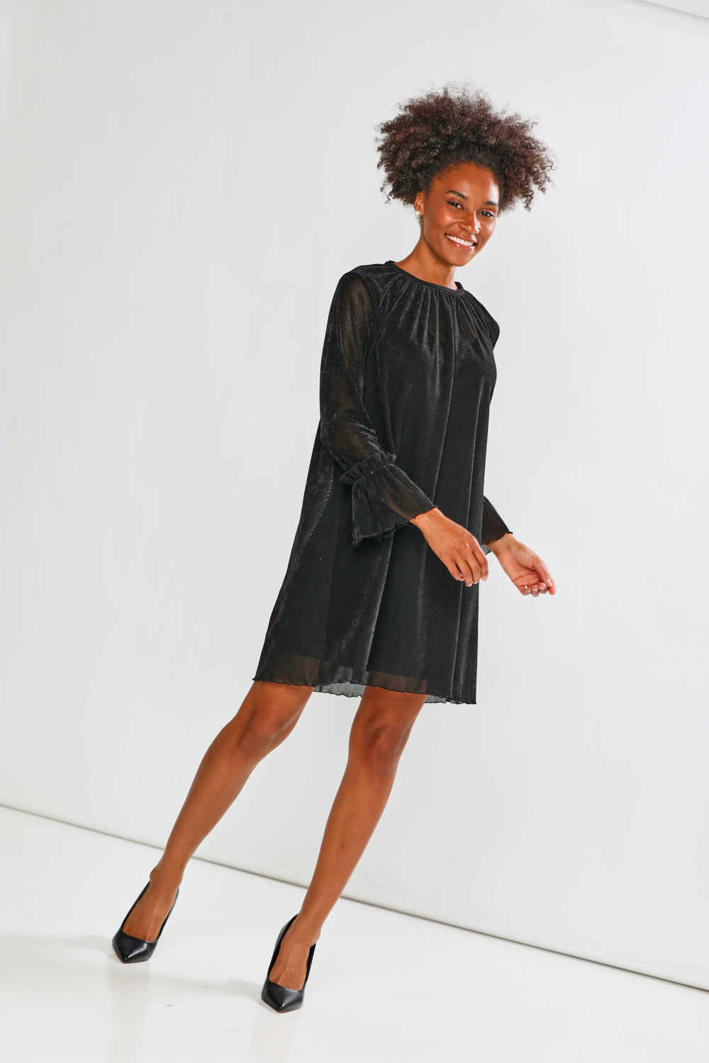 Woman wearing a black dress on a white background