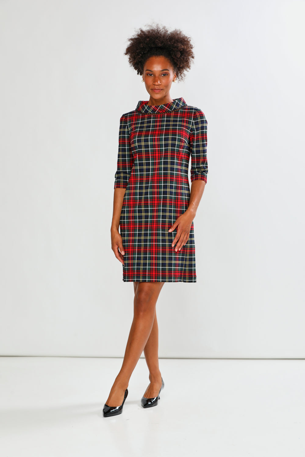 Woman wearing a plaid dress on a white background