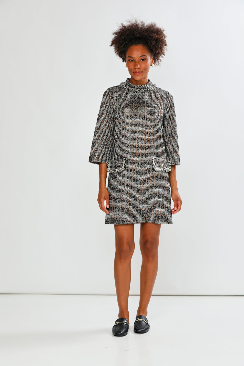 Woman wearing a textured dress against a white background