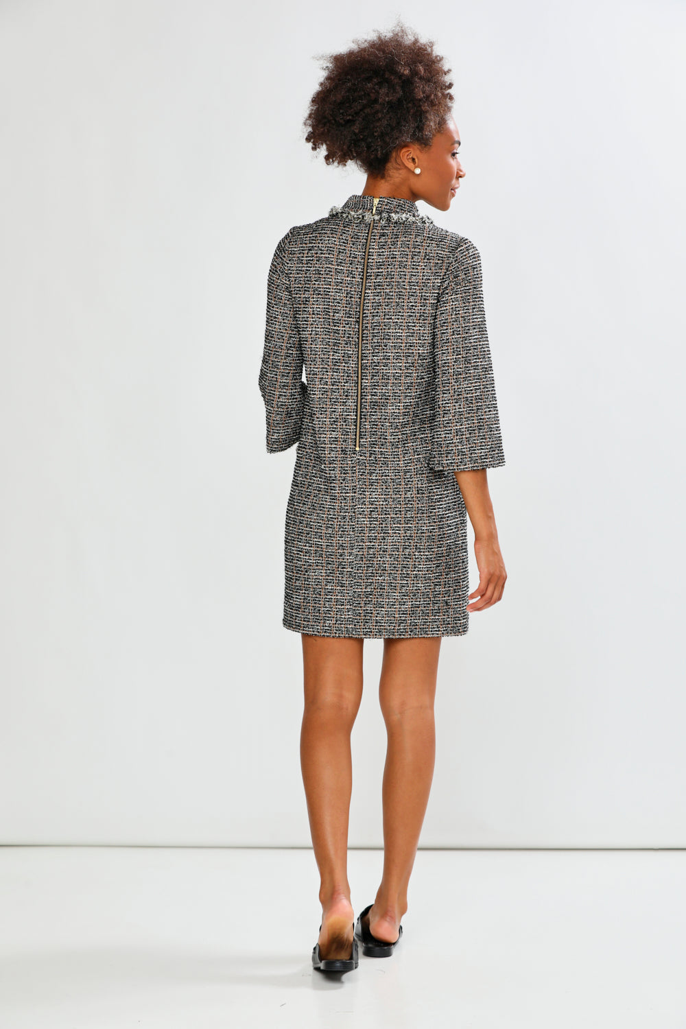 Woman wearing a patterned dress on a white background
