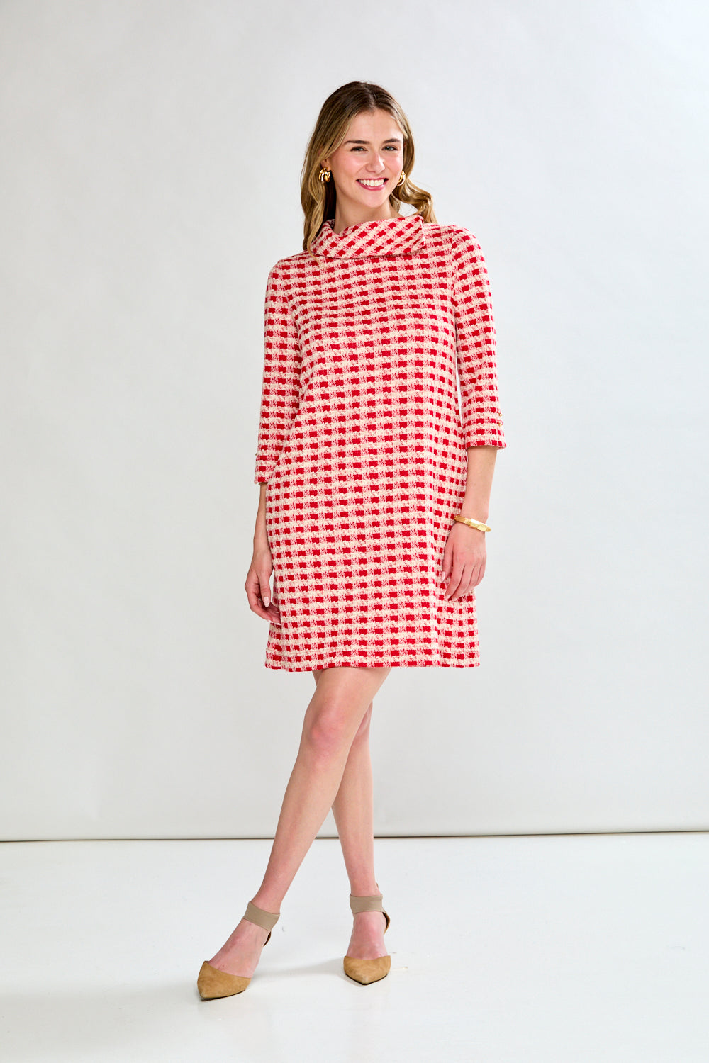 Woman wearing a red and white checkered dress on a white background