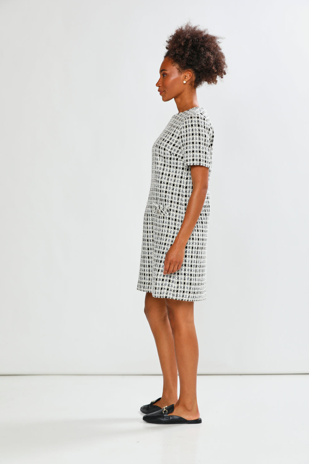 Woman wearing a patterned dress against a white background