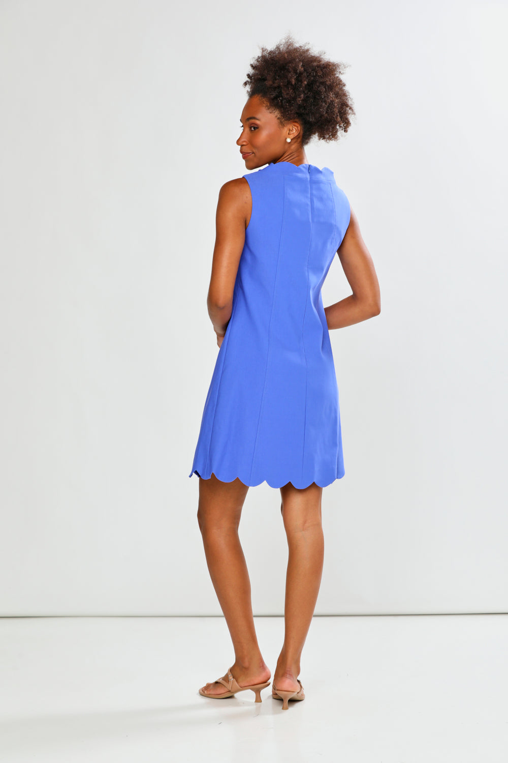 Woman wearing a blue dress against a white background