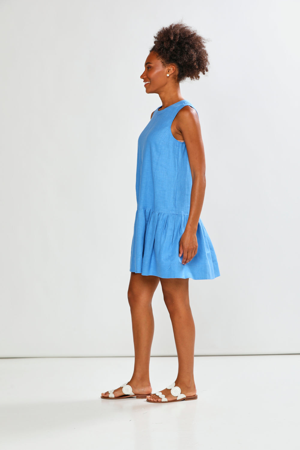 Woman wearing a light blue dress against a white background