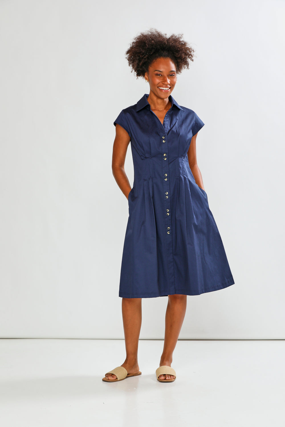 Woman wearing a blue dress against a white background