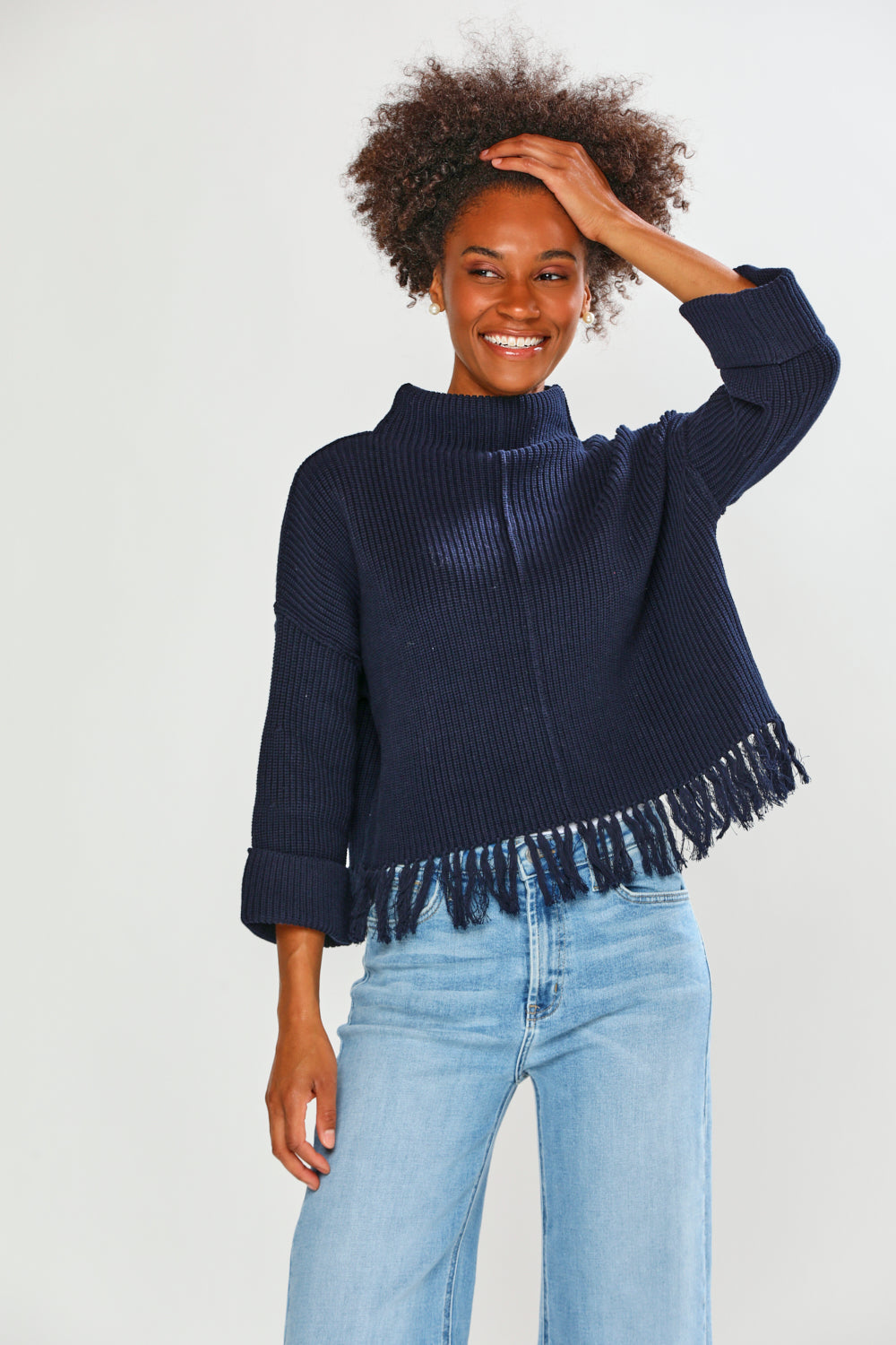 Woman in navy fringe edge sweater
