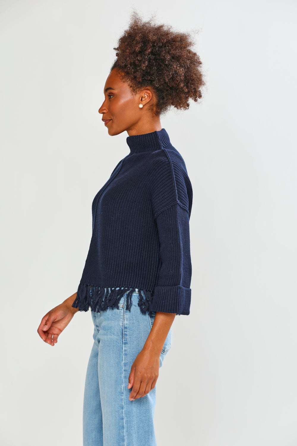 Woman in navy fringe edge sweater
