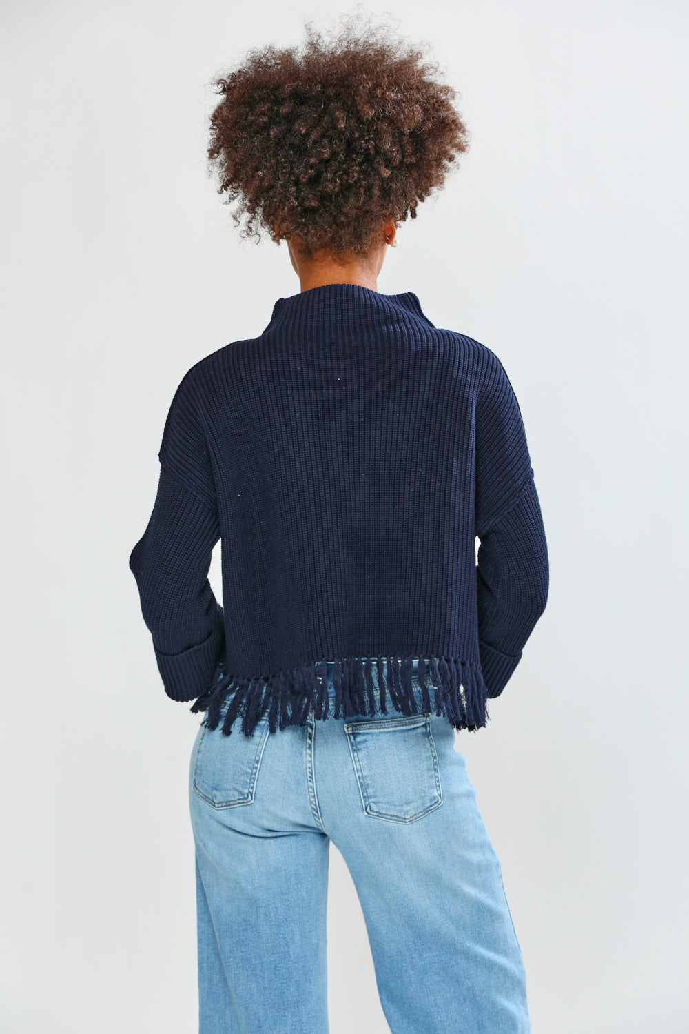 Woman in navy fringe edge sweater
