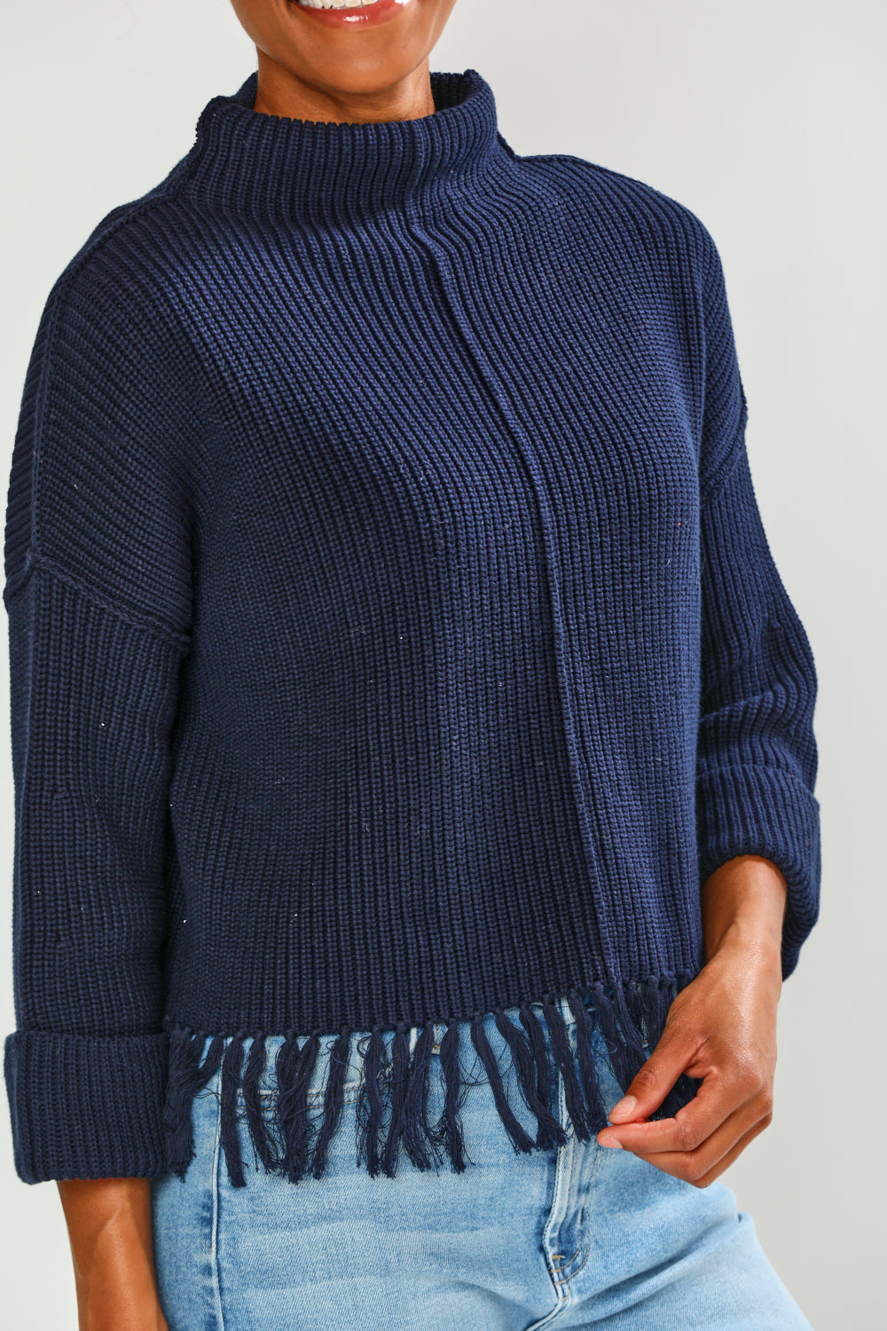 Woman in navy fringe edge sweater