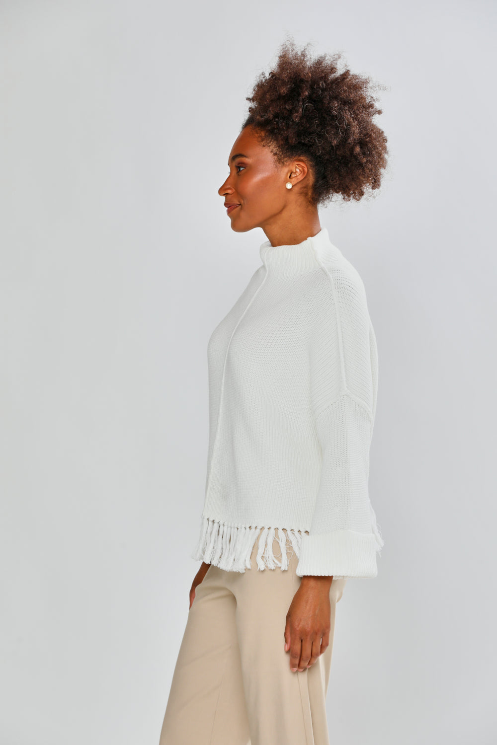 Woman in ivory fringe sweater