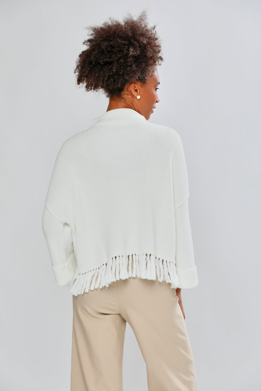 Woman in ivory fringe sweater