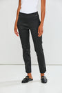 Person wearing black pants and black loafers on a white background